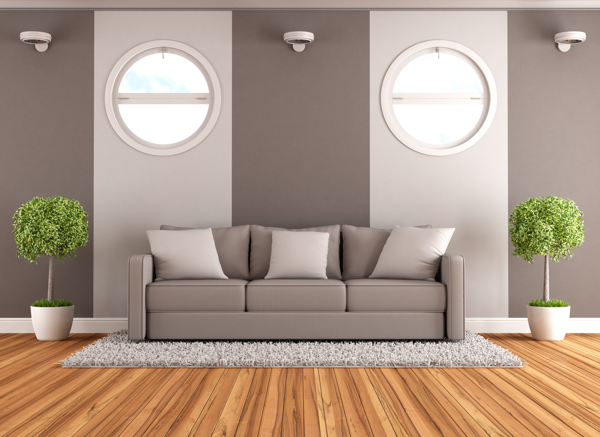 zwei rundförmige Fensterformen im Wohnzimmer über der Couch